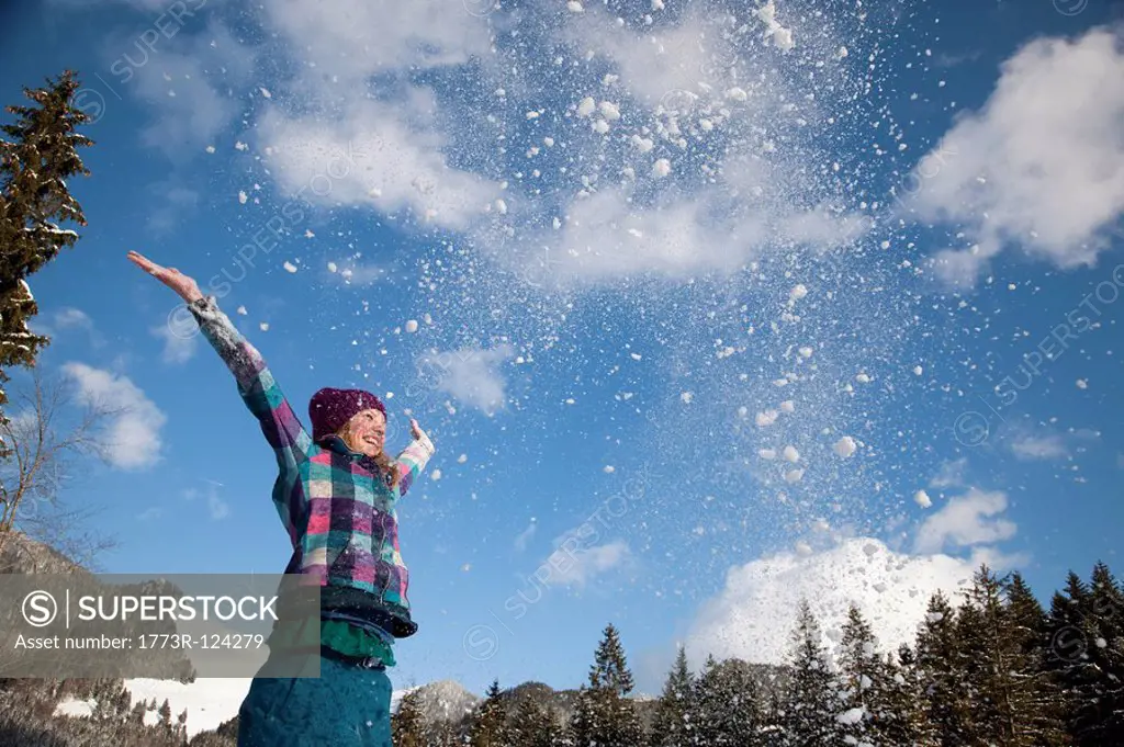 Girl throwing snow into the air