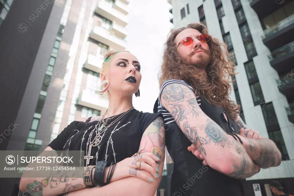 Low angle view of punk hippy couple with tattoos