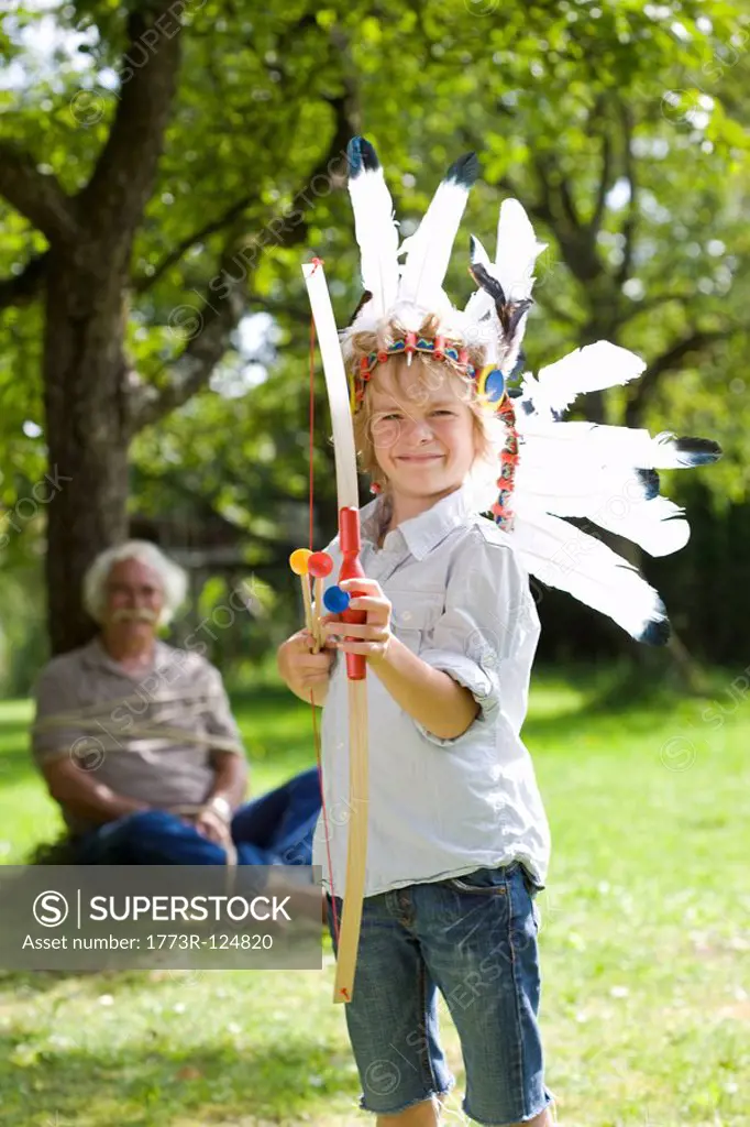 Disguised boy with toy bow and arrows