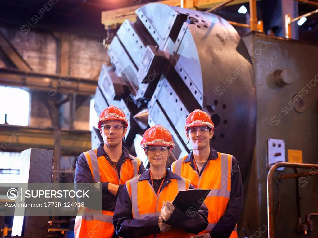 Steel Engineers In Front Of Lathe