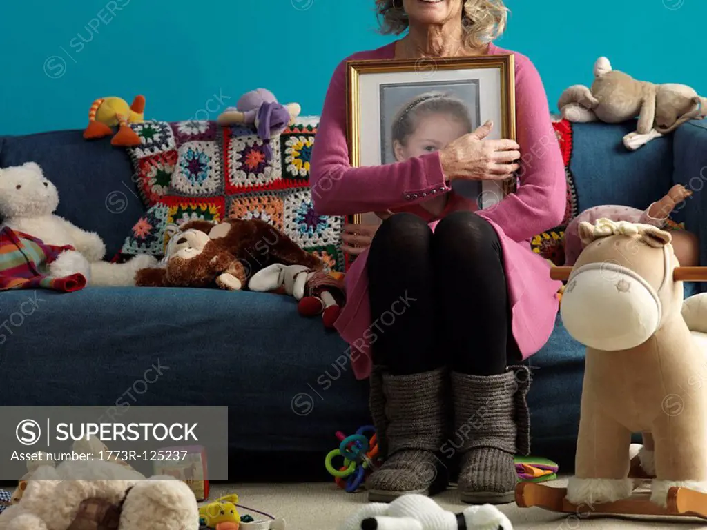 Mature woman holding picture of child