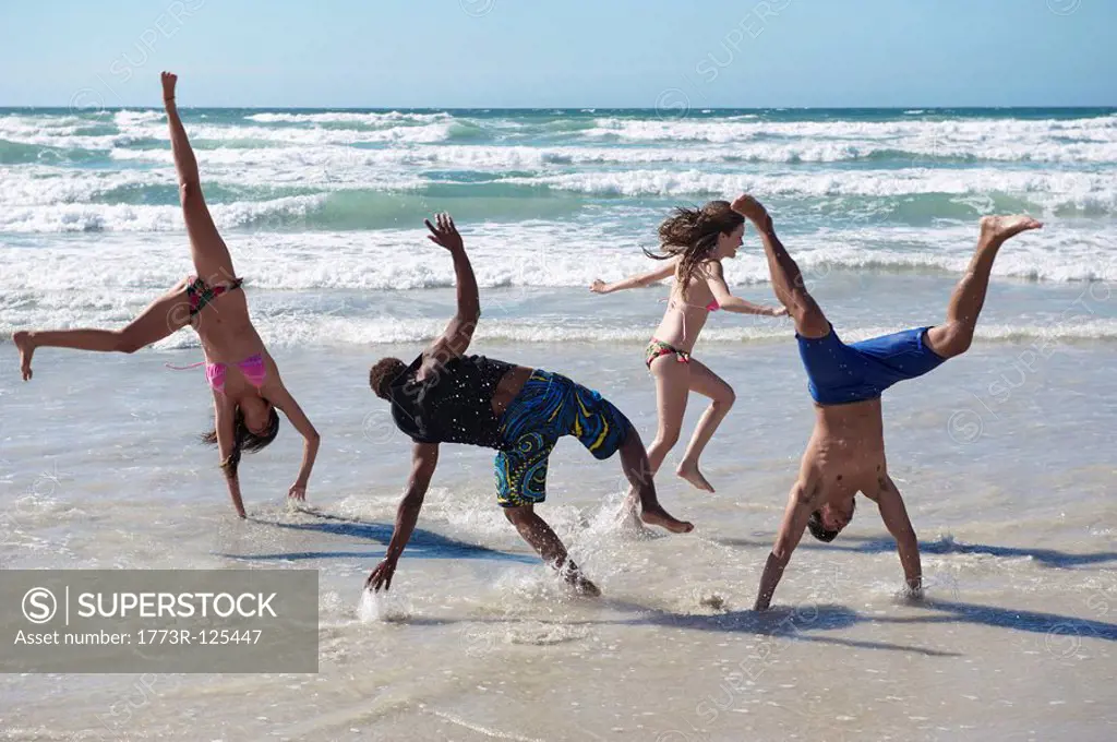 Young group frolicking on beach
