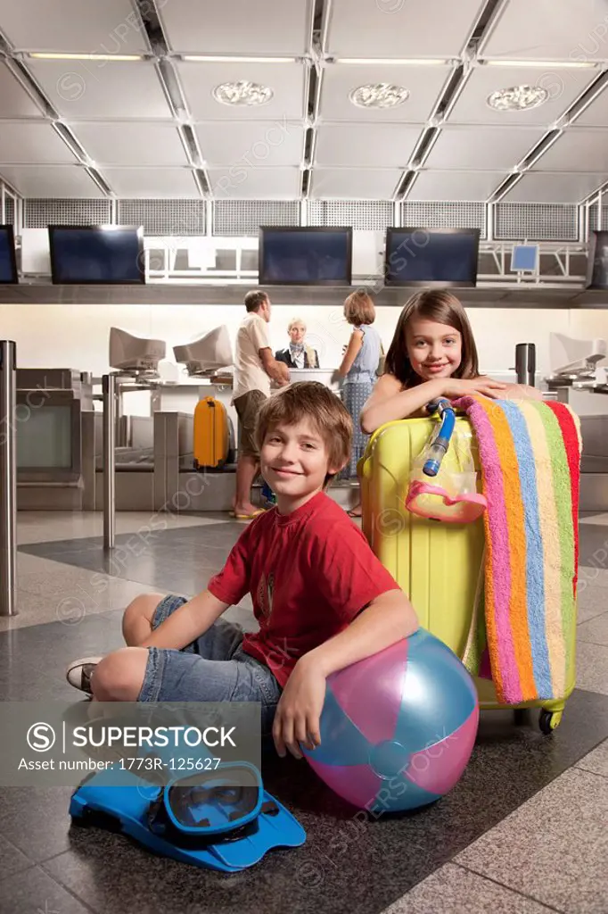 Children waiting at airport checkin