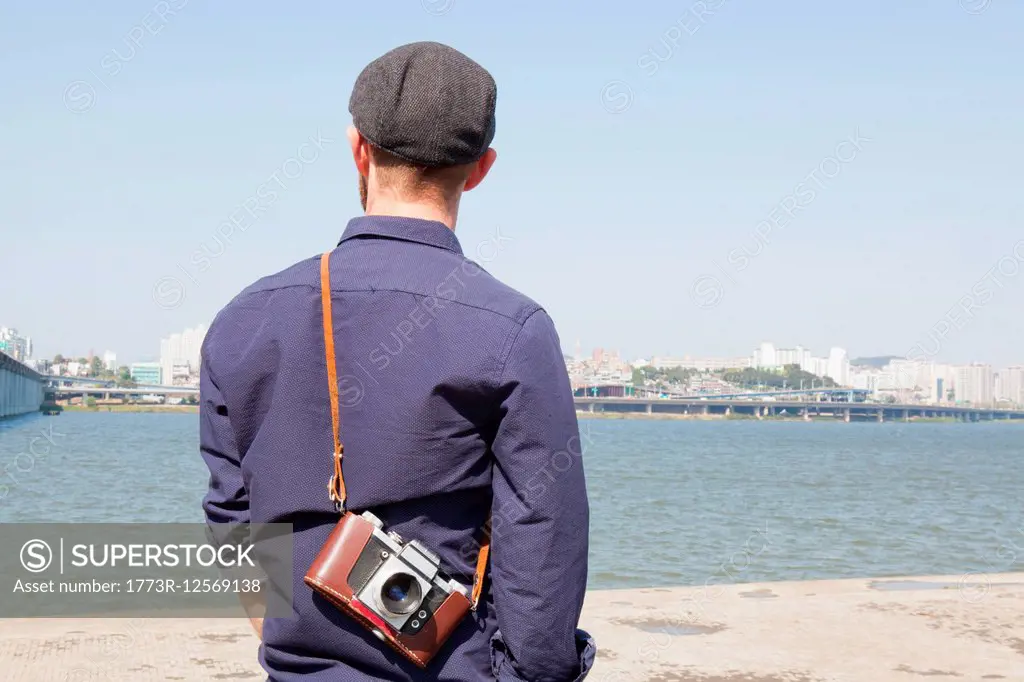 Rear view of male tourist looking at view of river, Seoul, South Korea