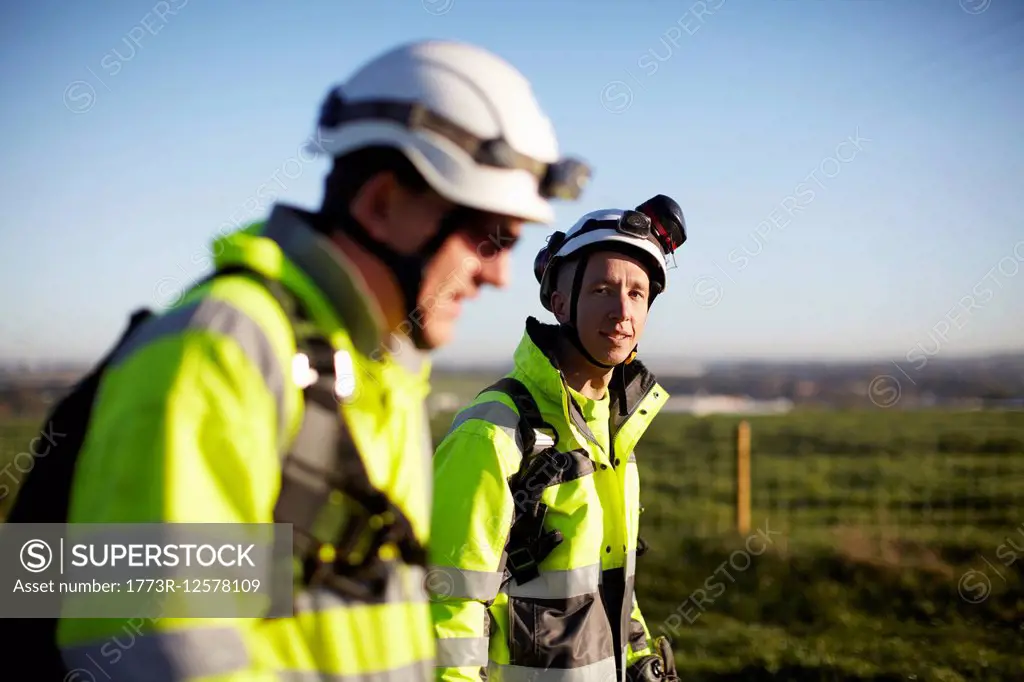 Two engineers at wind farm, walking together