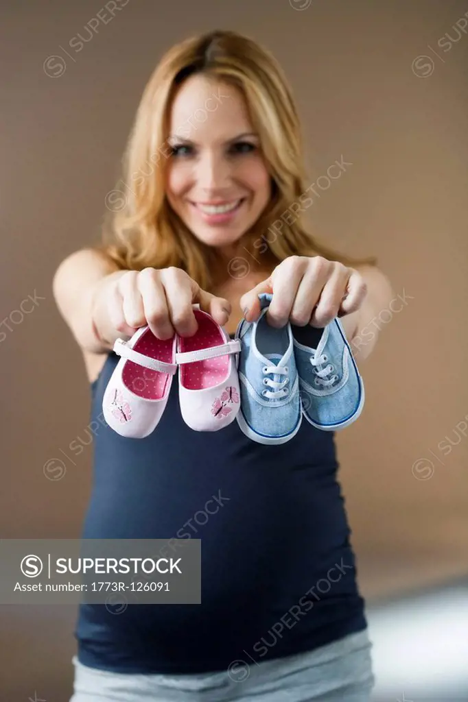 Woman showing baby shoes