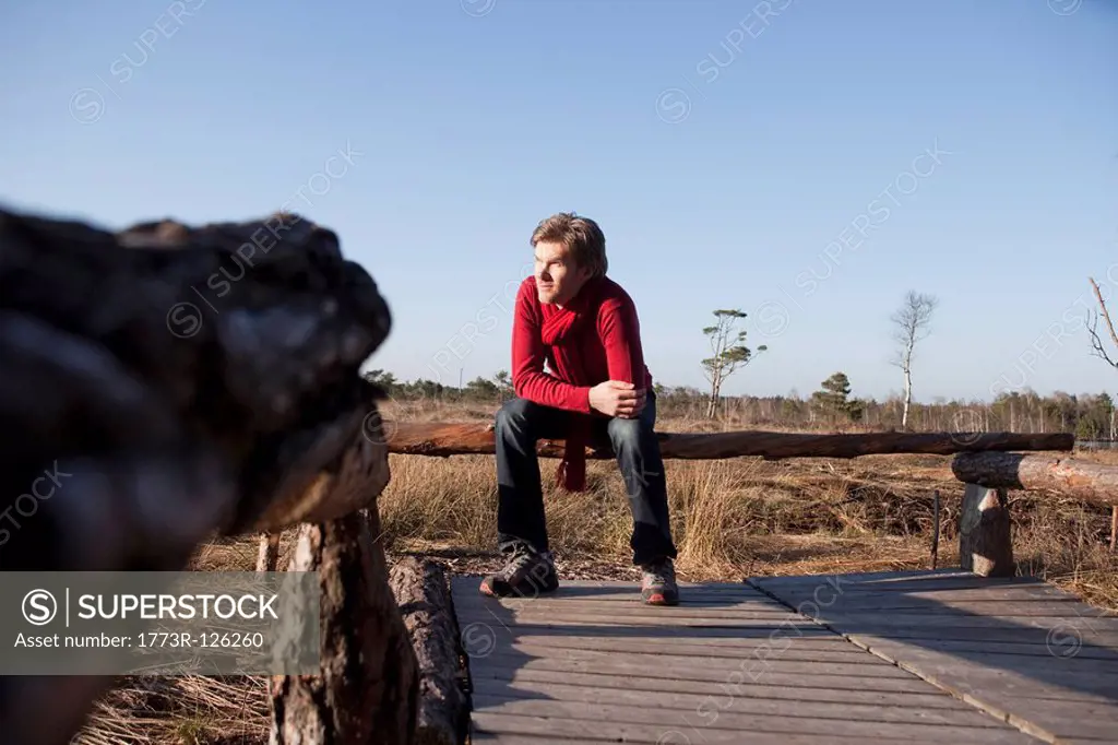 Man relaxing on wooden bench