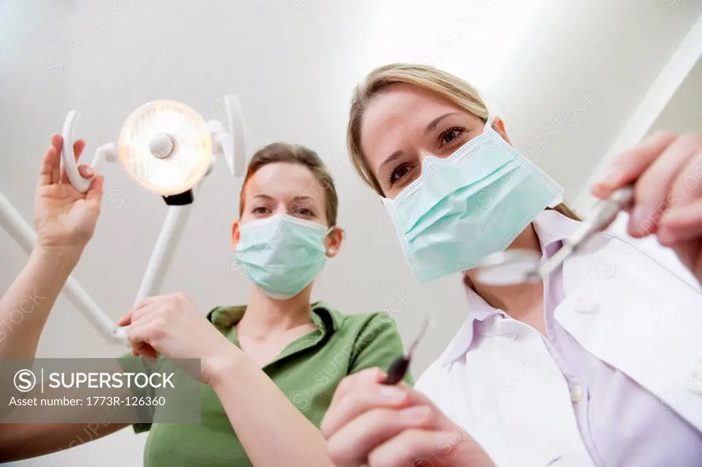 Dentist and dental technician in surgery