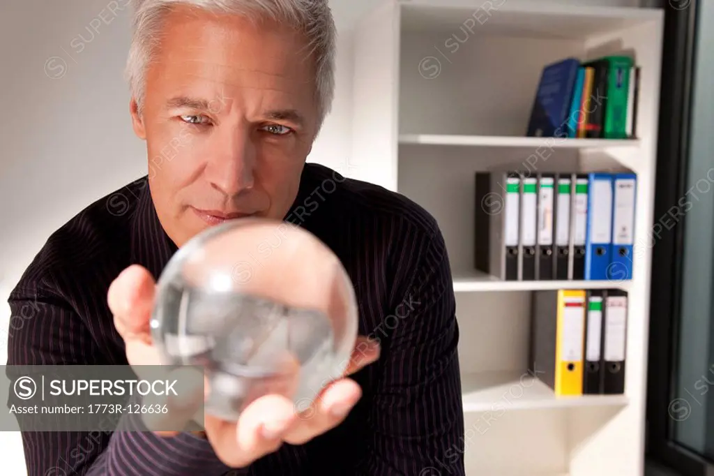 Businessman holding a crystal ball