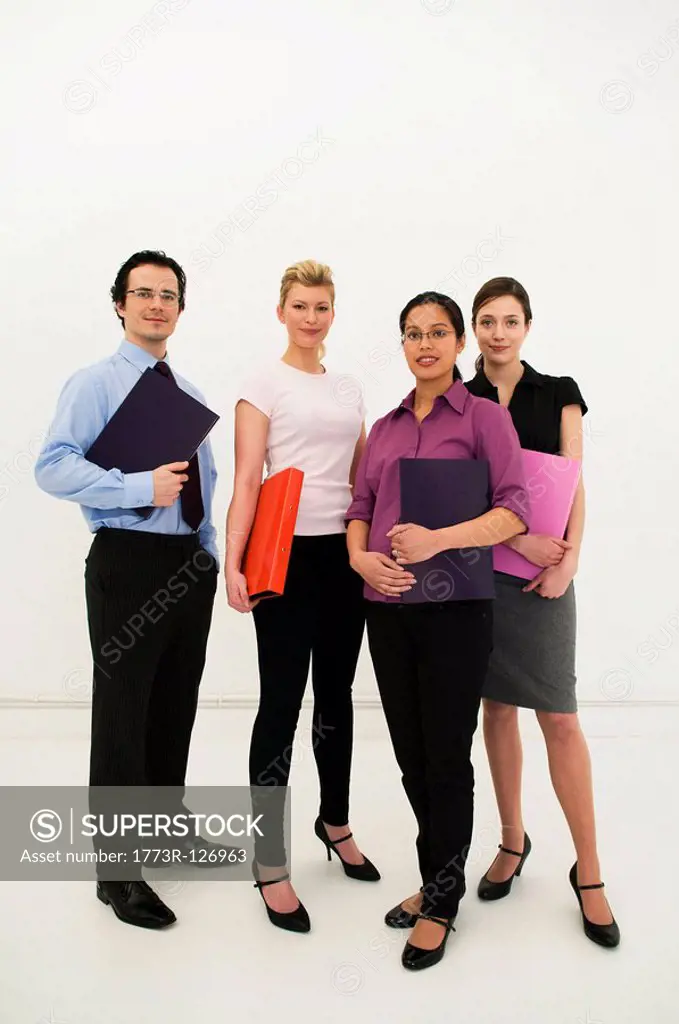 Four office workers look to camera
