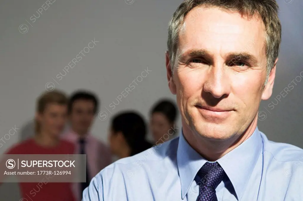Confident business man looks to camera