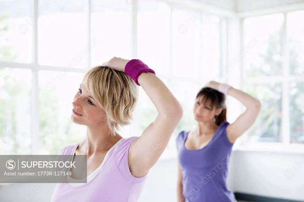 Two women stretching neck
