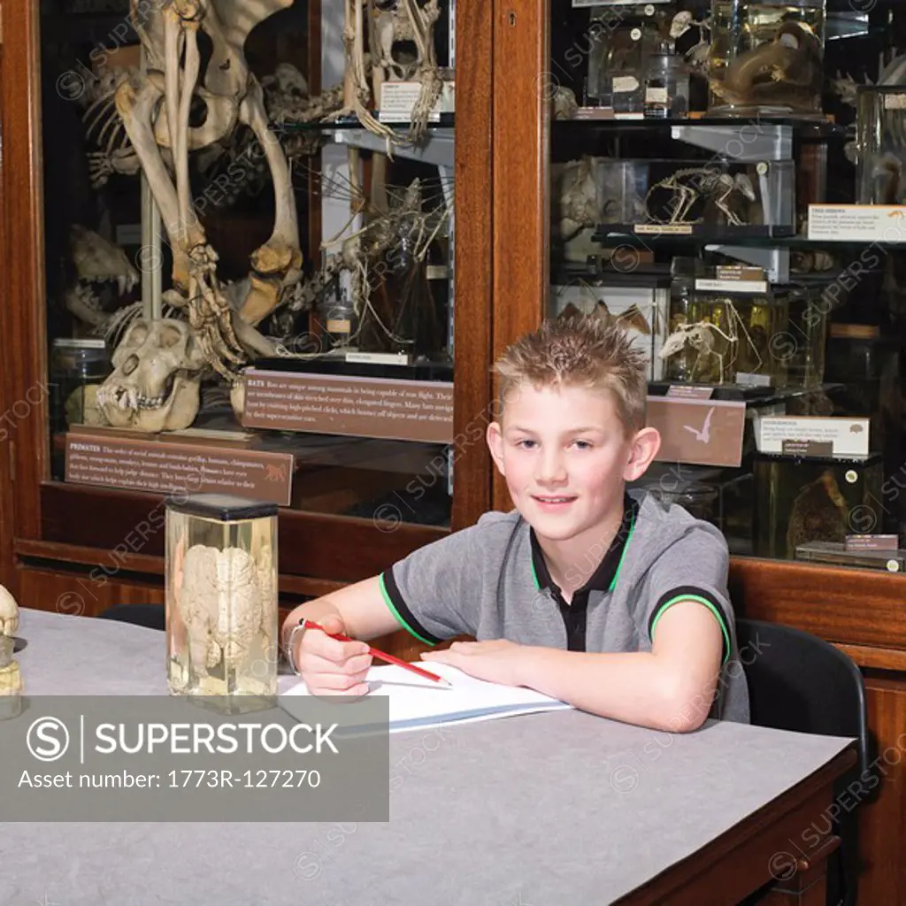 Boy in sitting at table in museum