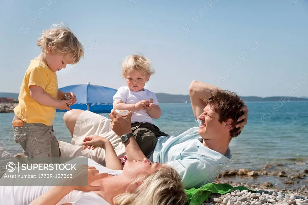 Family at the beach looking at shells