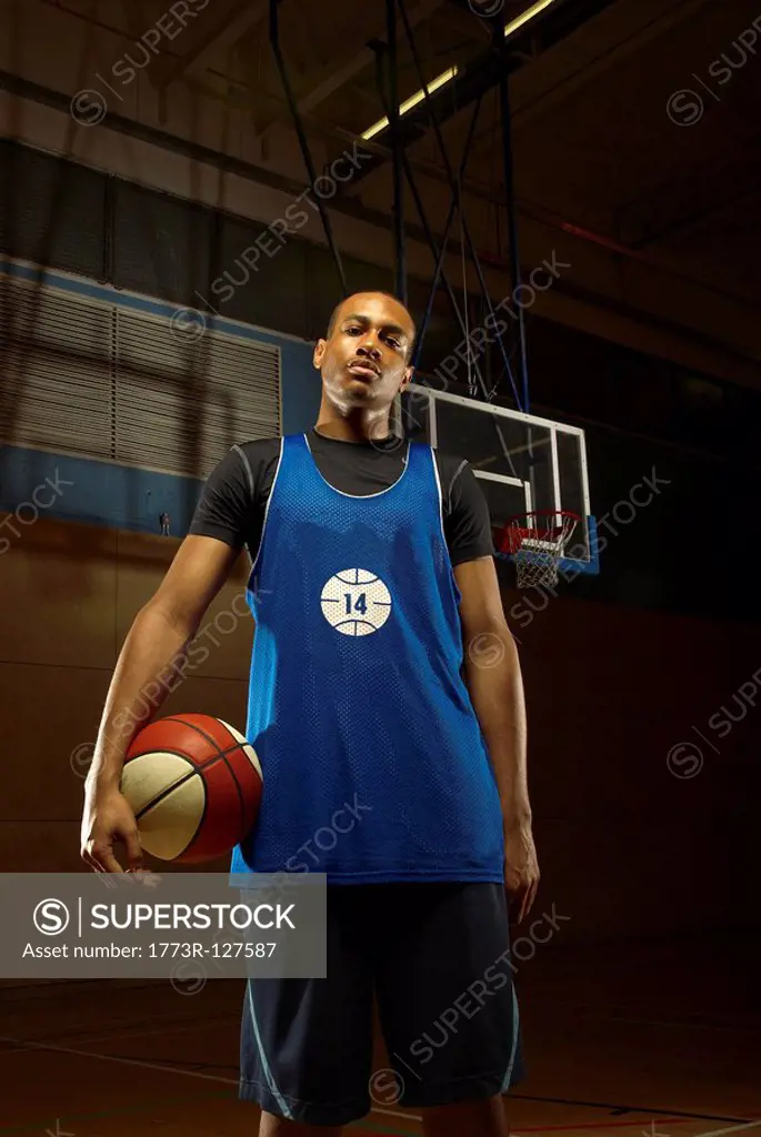 Single basketball player and ball