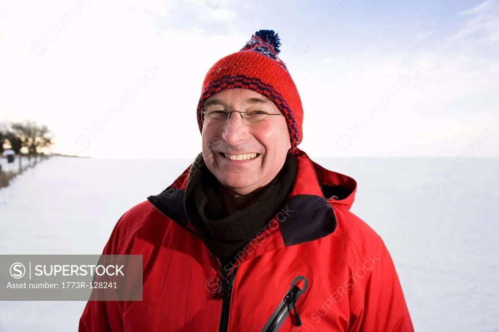 Senior man smiling in the snow