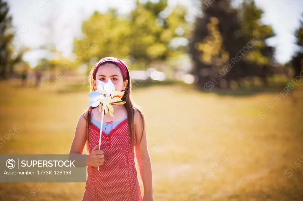 Young girl playing with wind wheel
