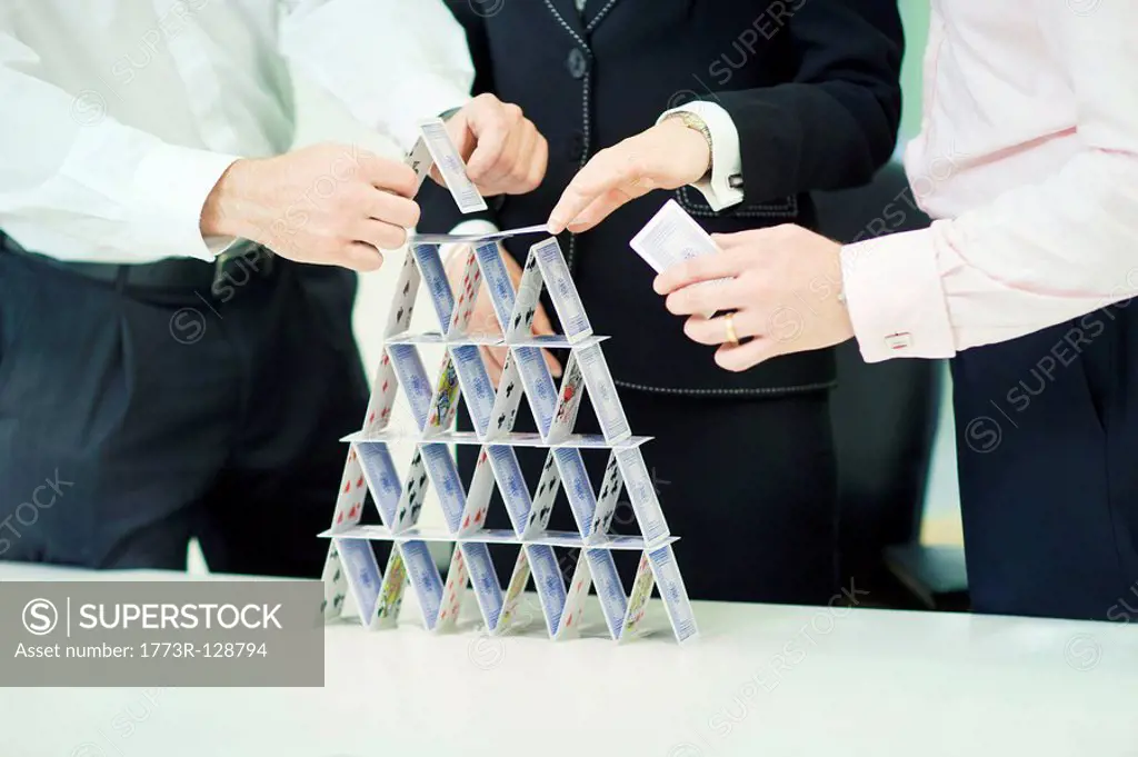 Businessman building house of cards