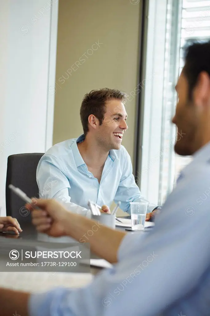 Smiling young man in business meeting