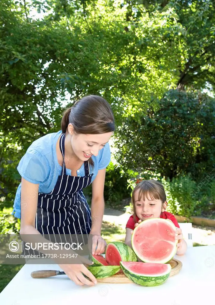 Mother and daughter prepare water melon