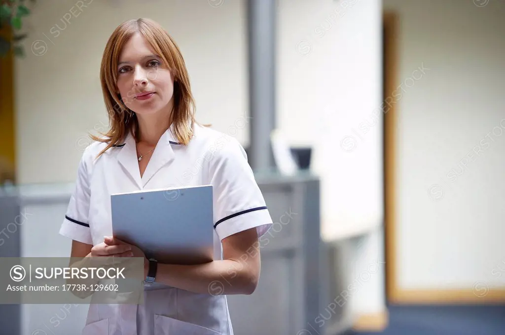 Nurse in reception area with clipboard