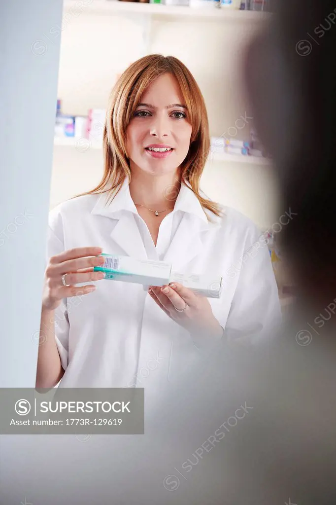 Pharmacist looking at pill box