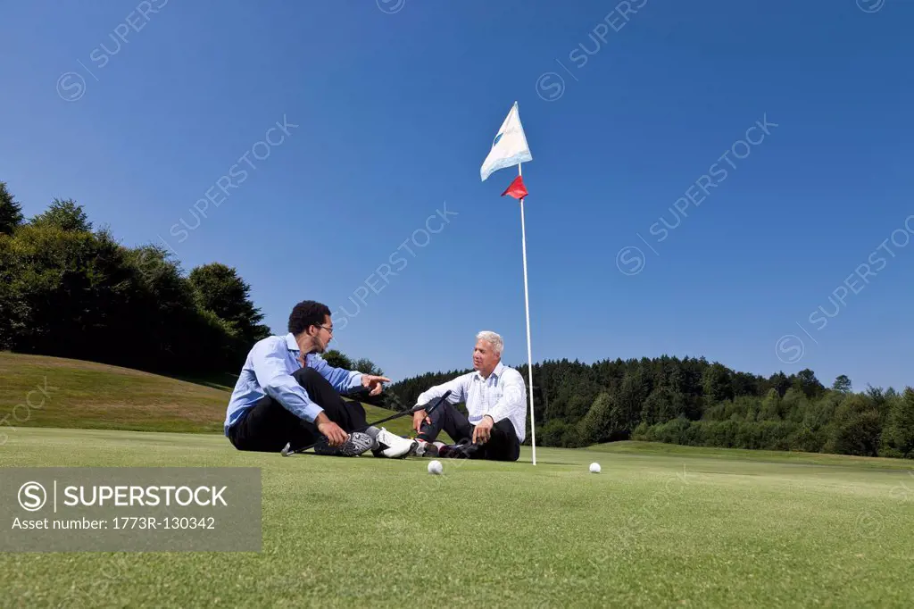 Sitting together on the putting green
