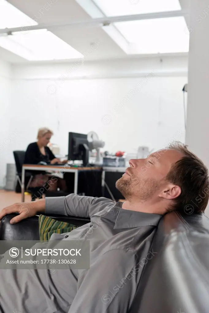 Man sleeping on sofa at the office
