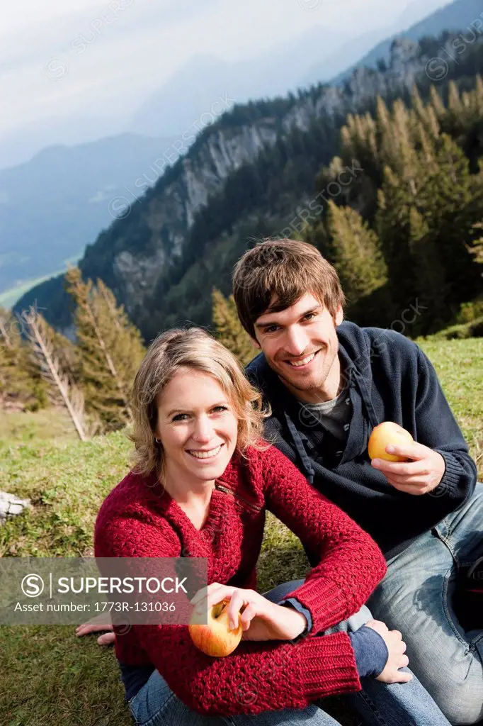 Couple eating apples while resting