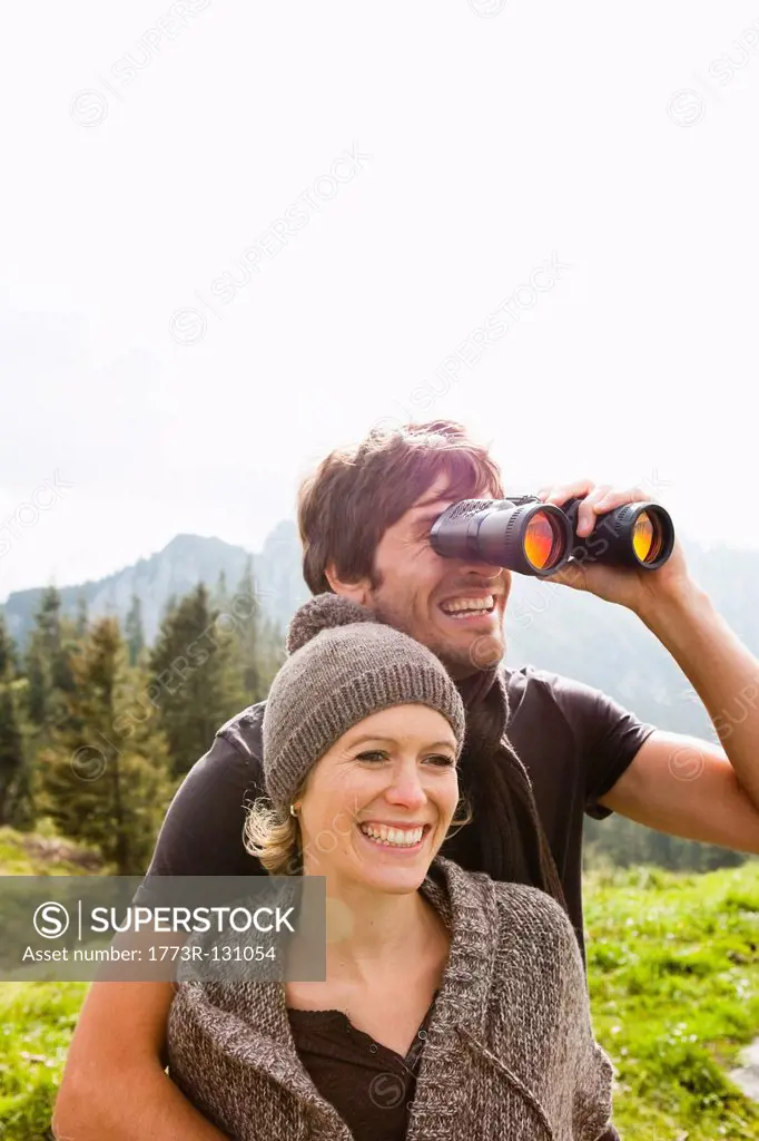 Couple with binoculars watching scenery