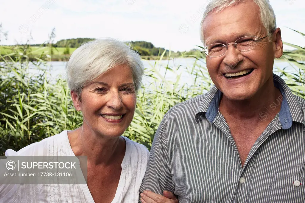 Senior couple outdoors smiling to camera