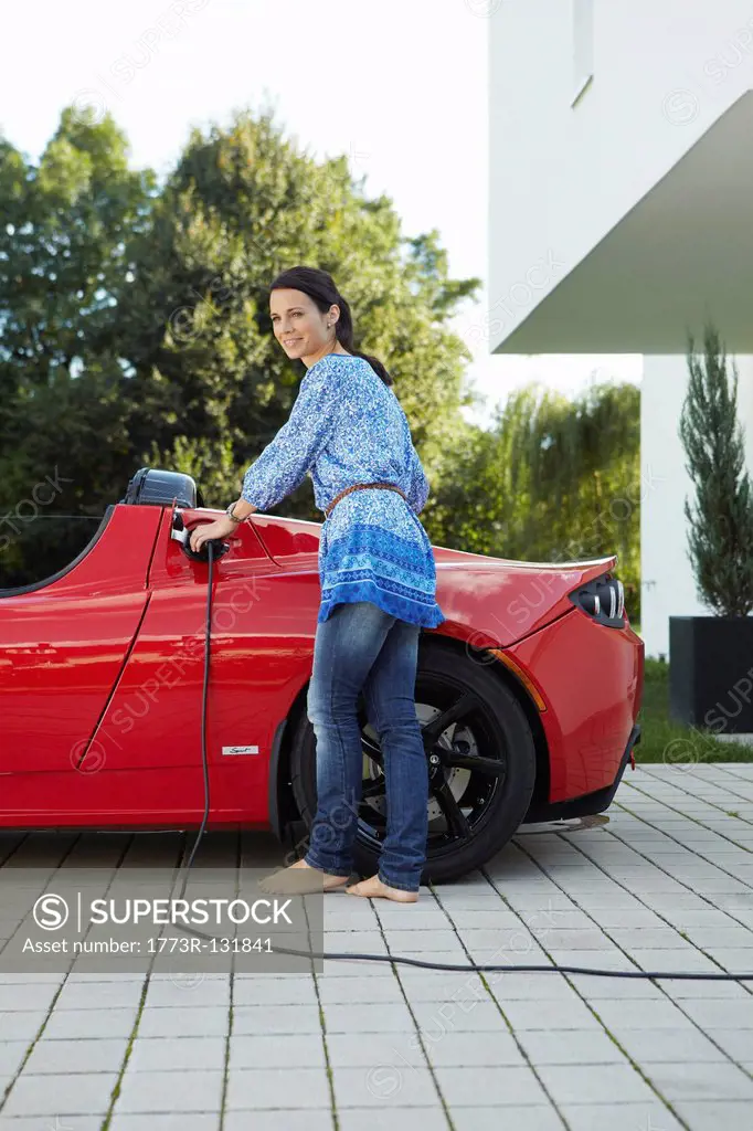 Women filling up her electric car