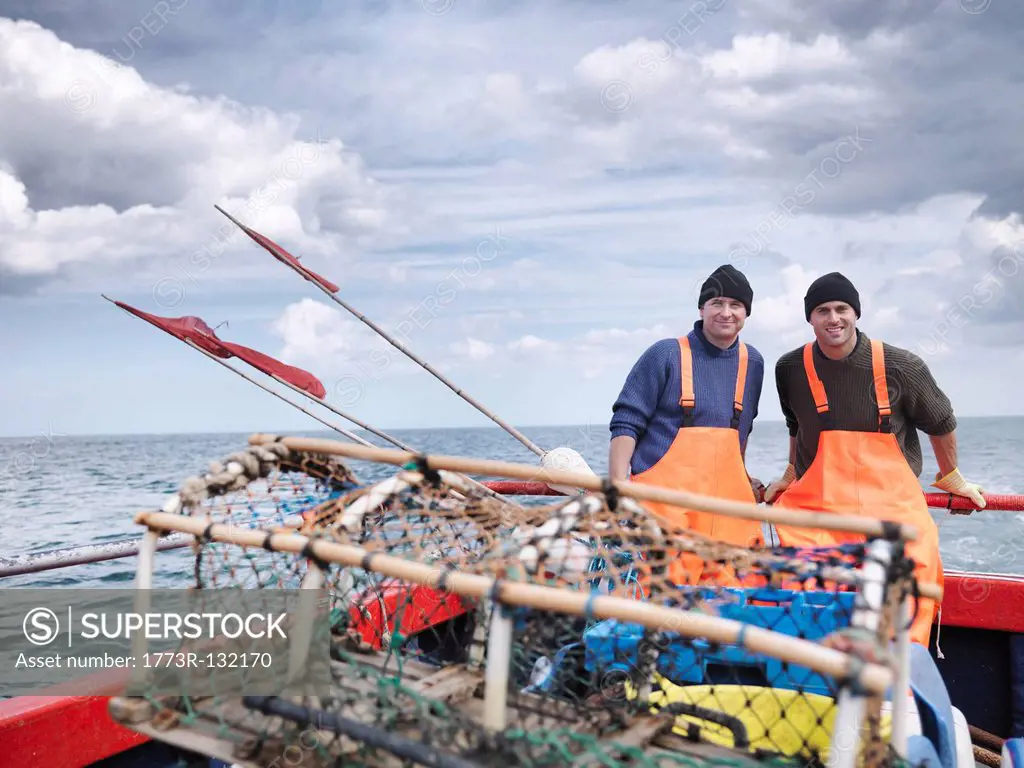 Fishermen on boat with lobster pot