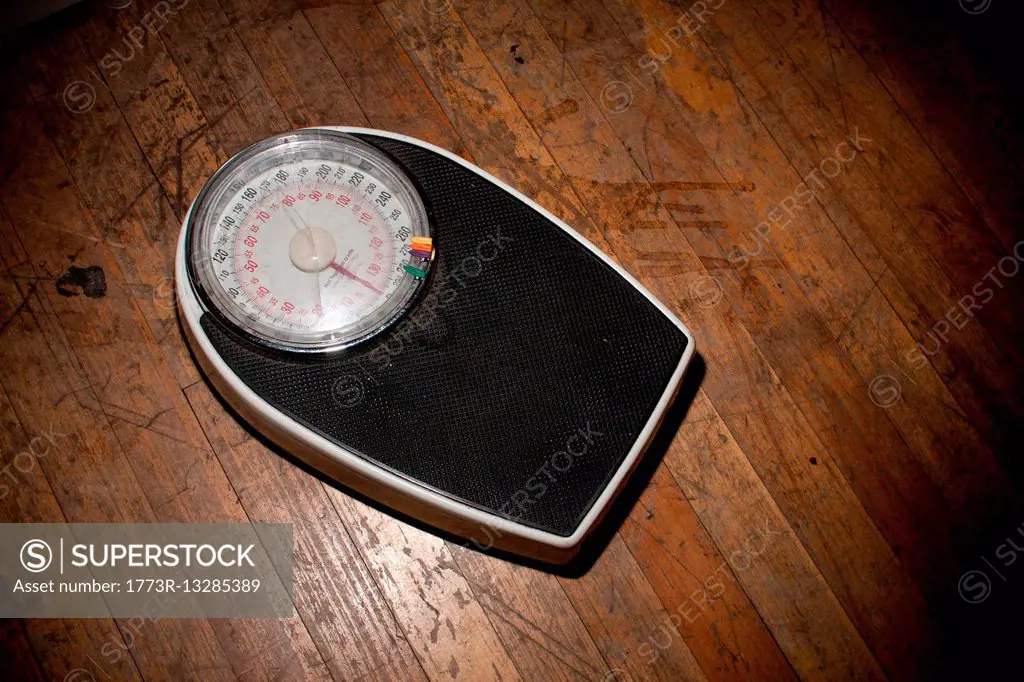 Weighing scales on wooden floor
