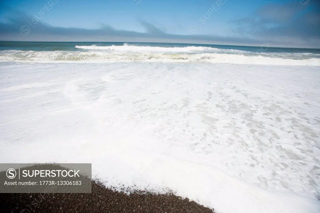 Sea surf at water's edge