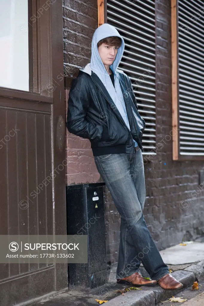 Male with hooded top waiting in street