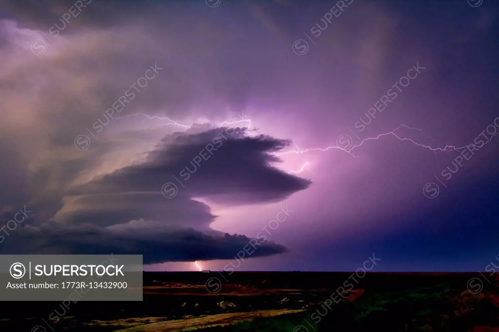 Lightning sparks from a spinning supercell thunderstorm at night near Leoti, Kansas