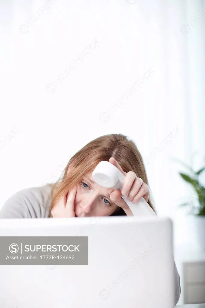 Worried girl looking at laptop