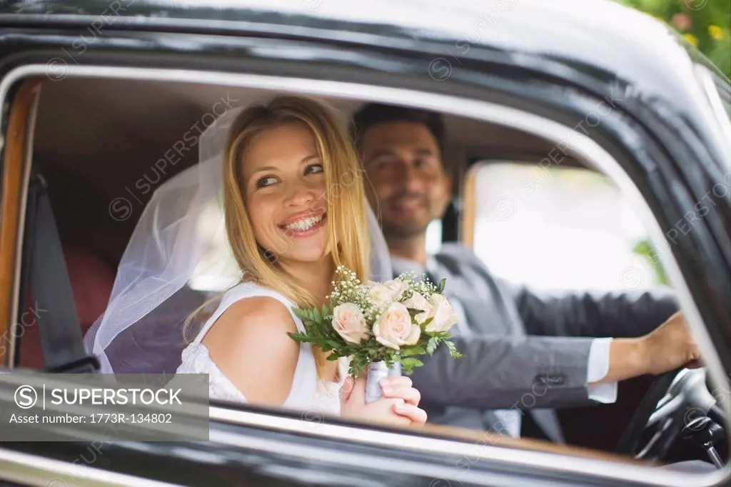 Bridal couple in car