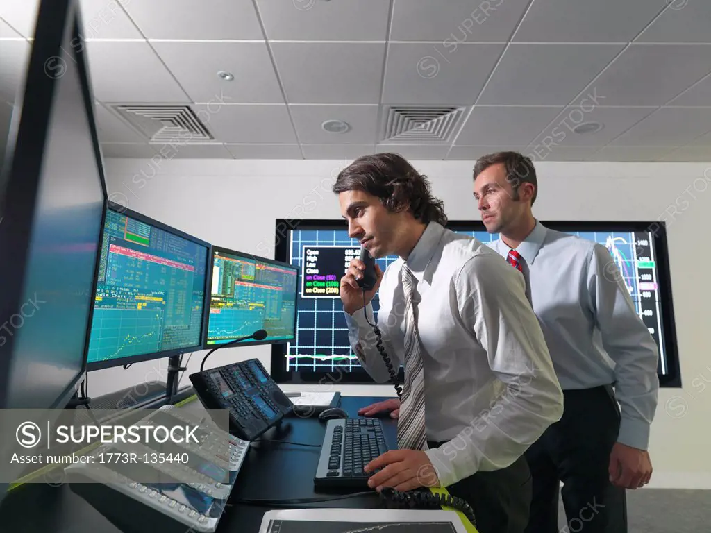 Financial trader with screens