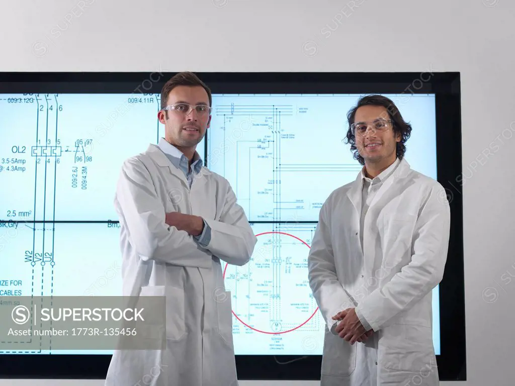 Scientists with diagrams on screen