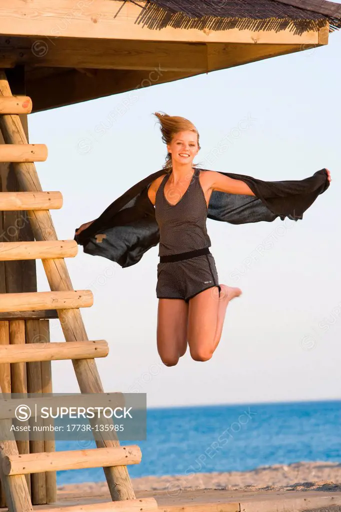 Beautiful girl jumping beach