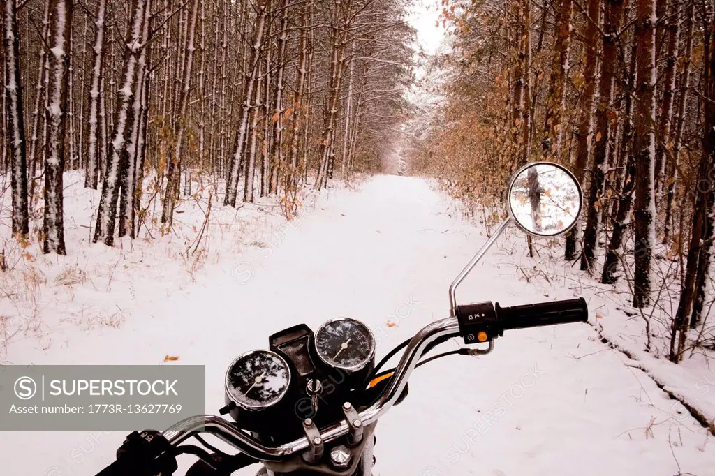 Motorbike parked in snowy forest