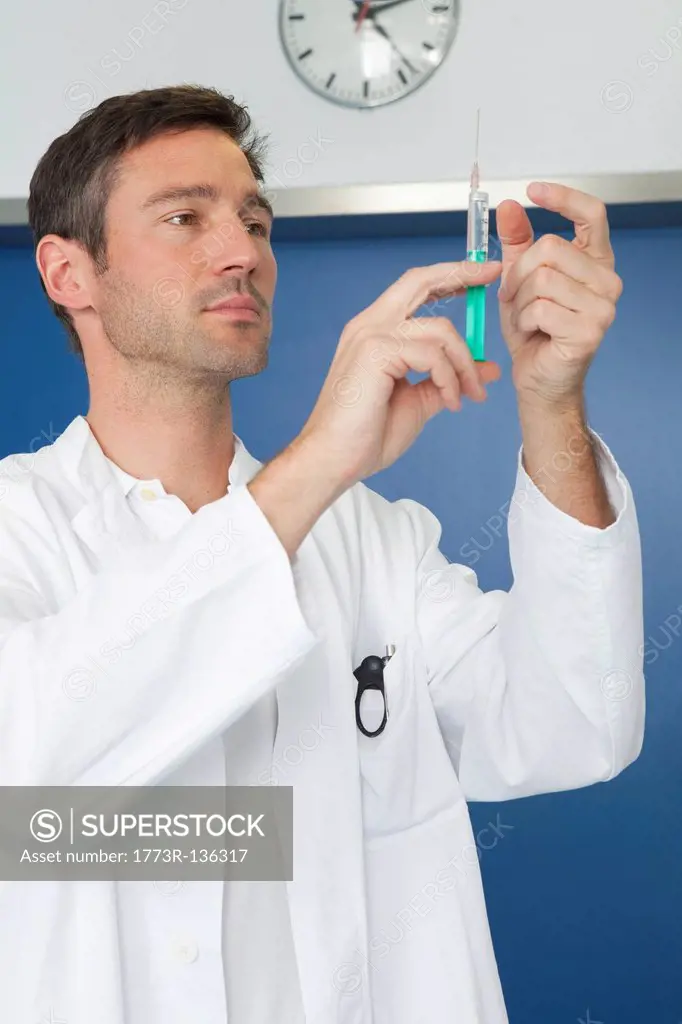 Doctor inspecting injection