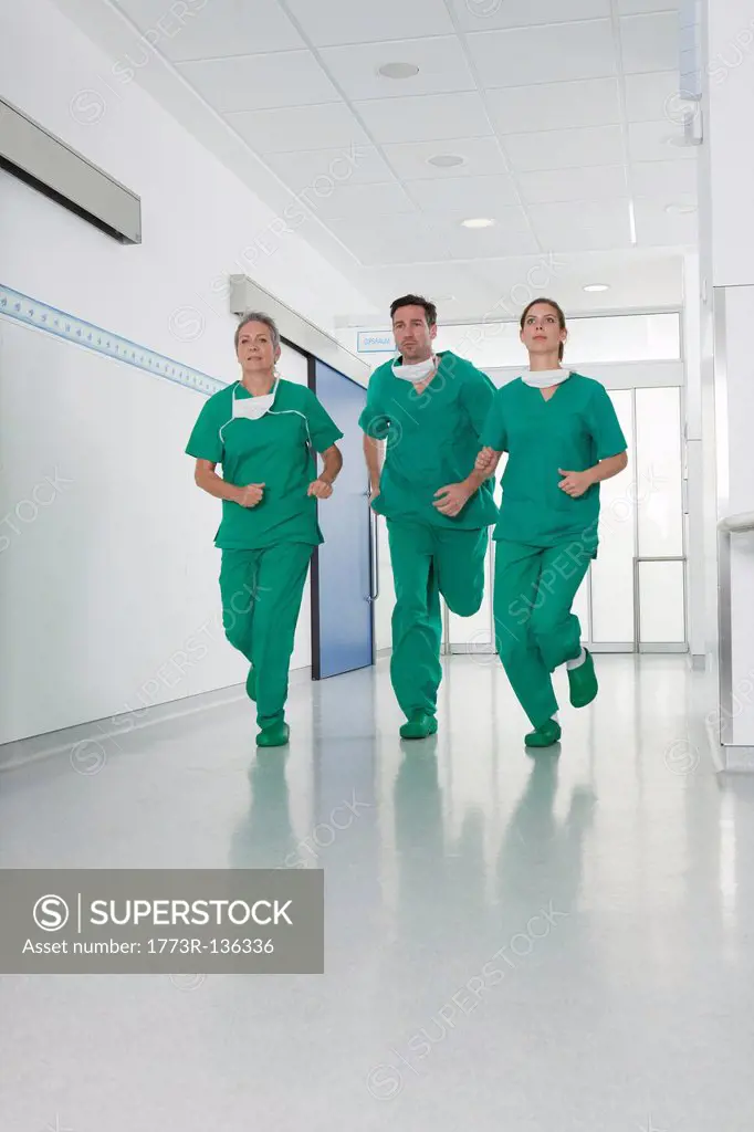 Medical team in scrubs rushing in hall