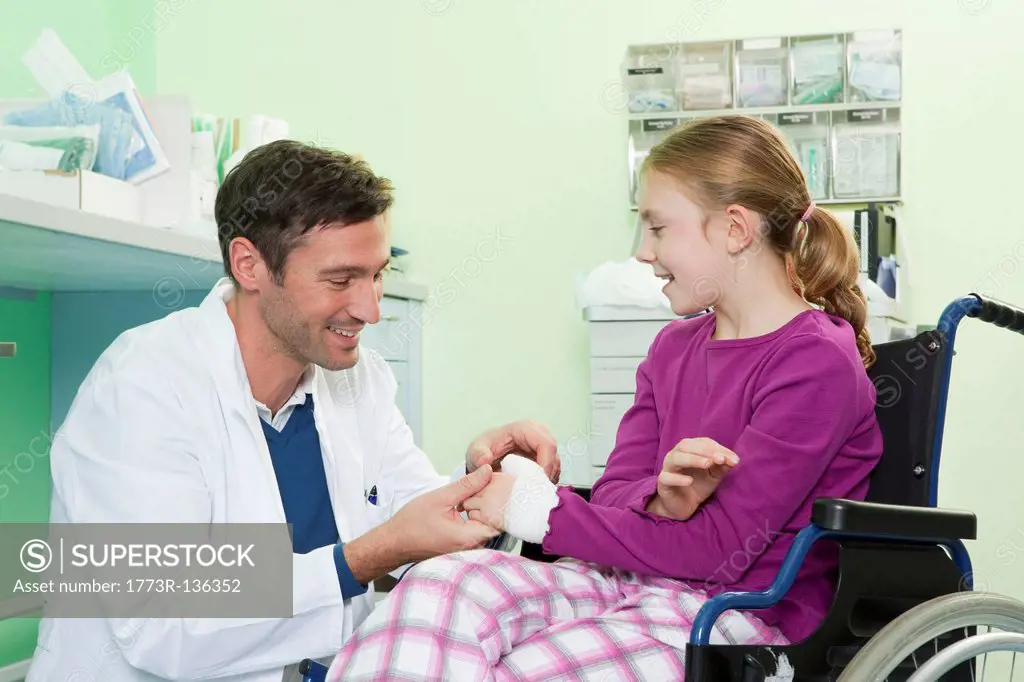 Doctor examining girls hand
