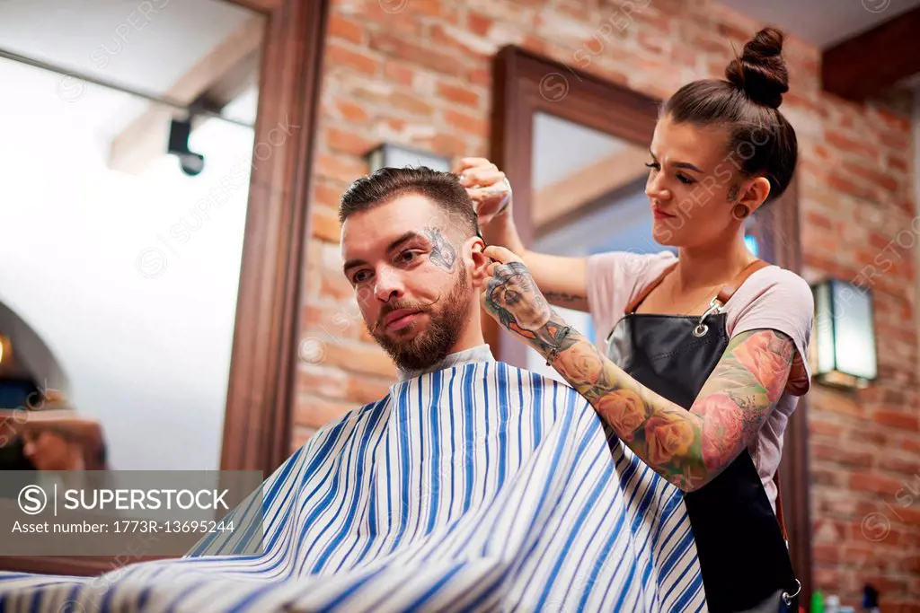 Hairdresser cutting customer's hair