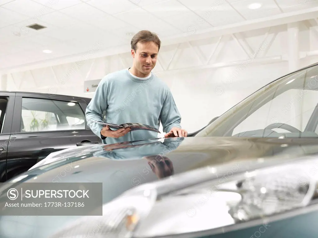 Customer looks at car in car dealership