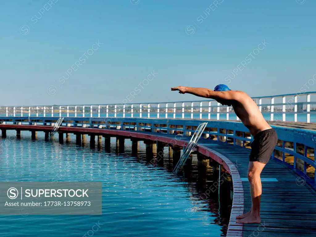 Swimmer diving from boardwalk, Eastern Beach, Geelong, Victoria, Australia