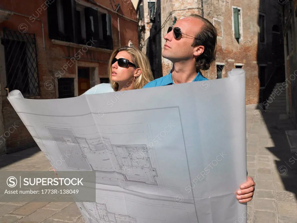 Couple looking at blue prints
